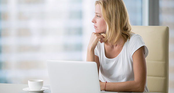 woman thinking with laptop