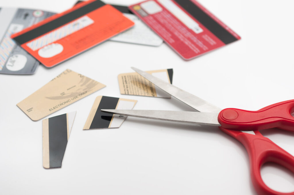 Cuting credit cards with scissors - Prudent Financial Solutions