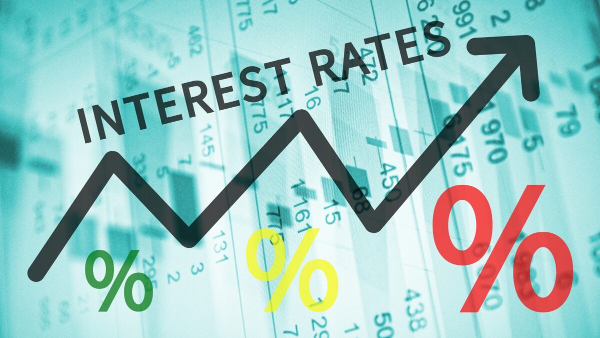 Text Interest rates on up trend arrow, with financial data visible - Prudent Financial Solutions