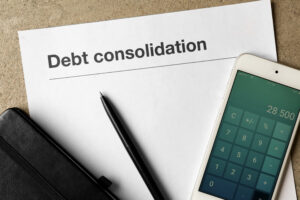 pen and calculator app on top of debt consolidation form
